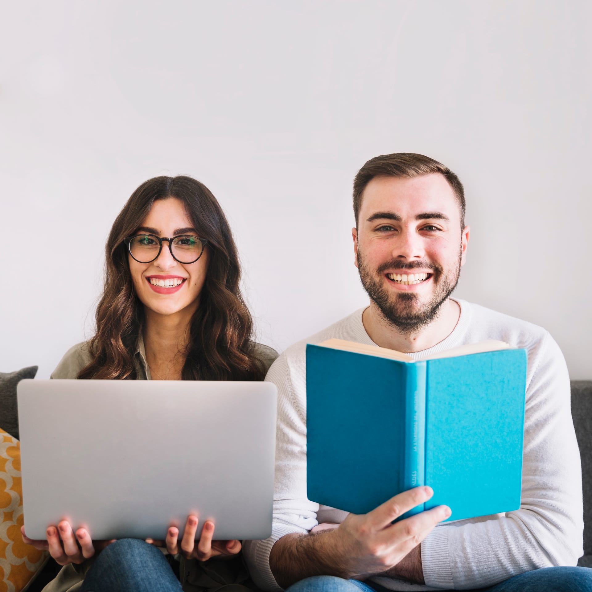 People collaborating with laptops around a table